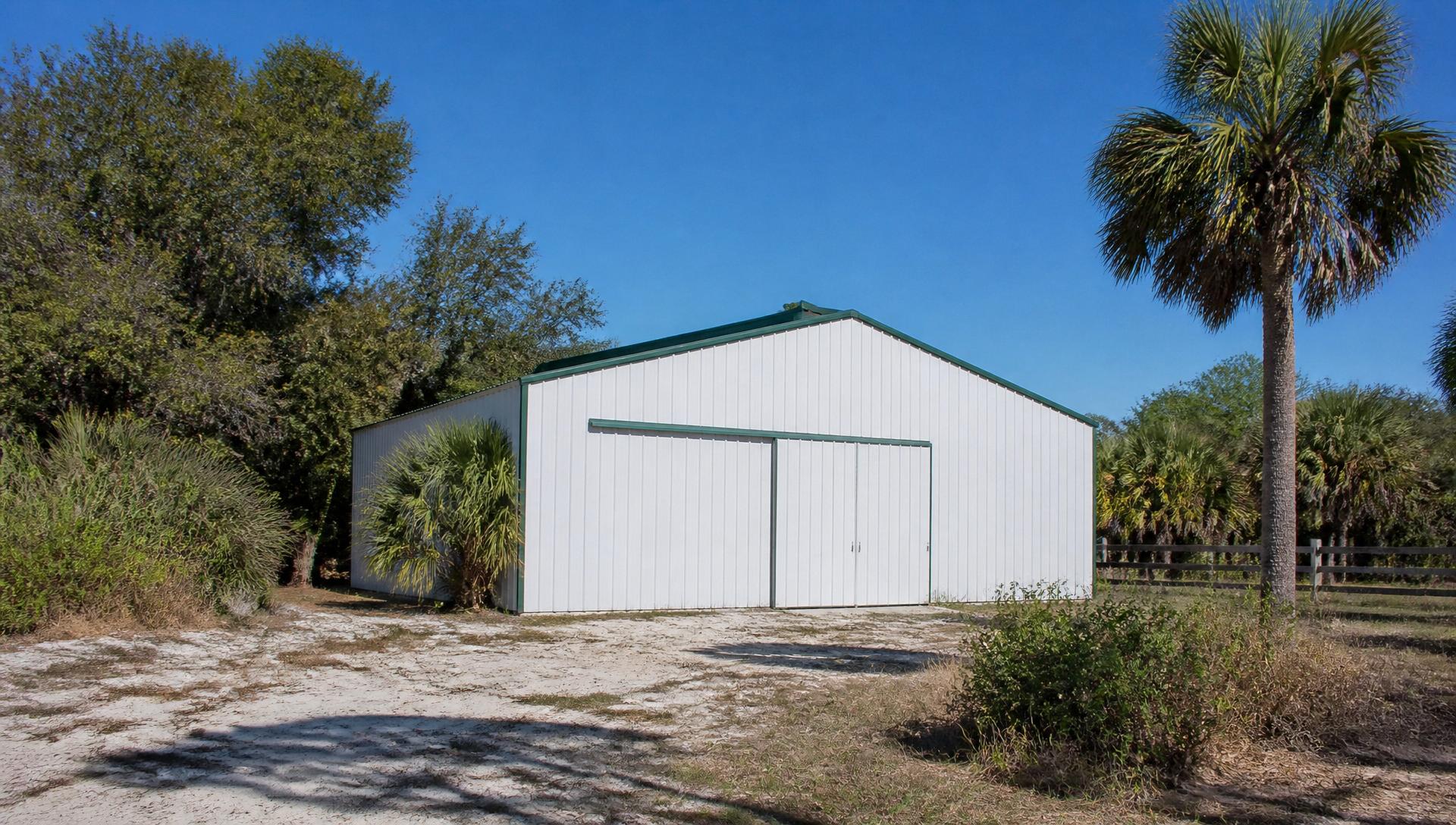 Enclosed Florida pole barn with green trim